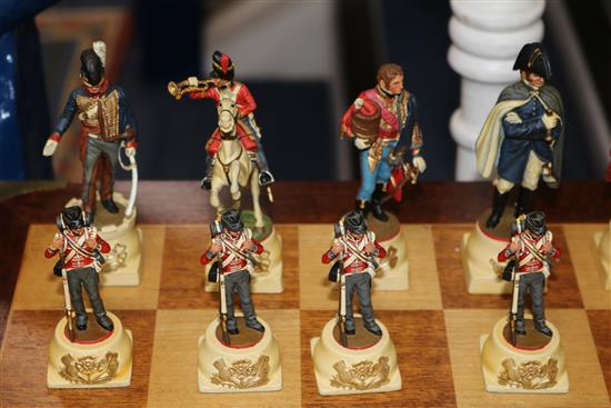 A Waterloo chess set by Charles Stadden, No. 27/250, in military style brass-bound mahogany games table on folding stand